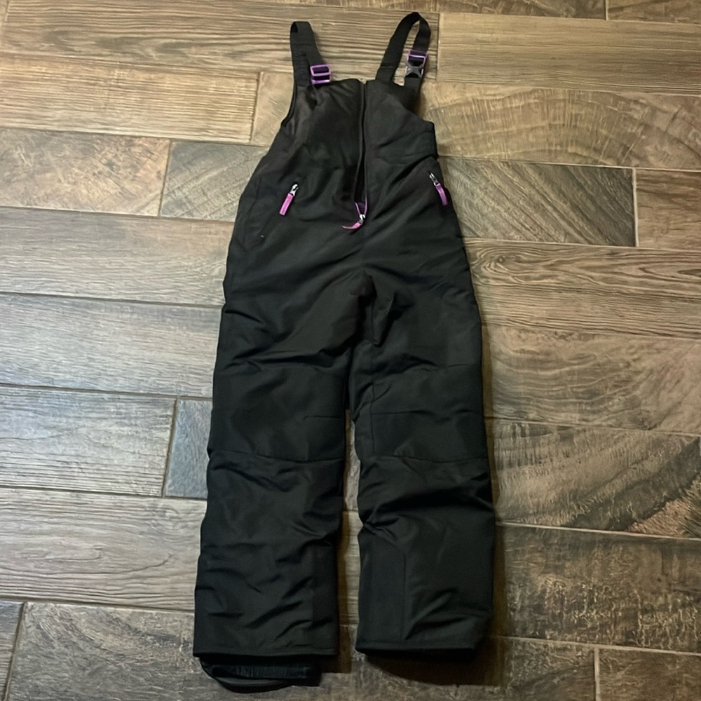 Black with purple accents, girls, snow bib size large. Excellent condition.